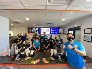 franchise location team posing by counter